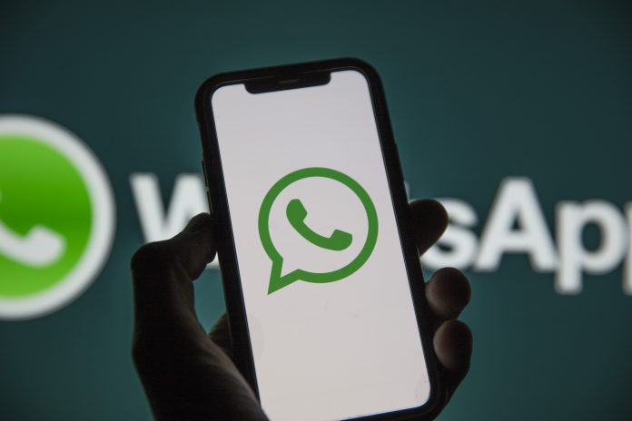 LONDON, UK - March 2021: Whatsapp online messaging service logo on a smartphone