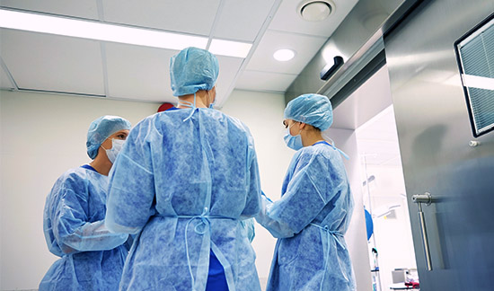 group of surgeons in operating room at hospital