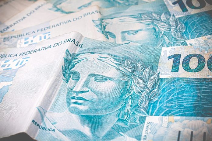 Brazilian Currency. Real, Money, Dinheiro, Brazil. Several cash notes of 100 reais and 50 reais on a table.